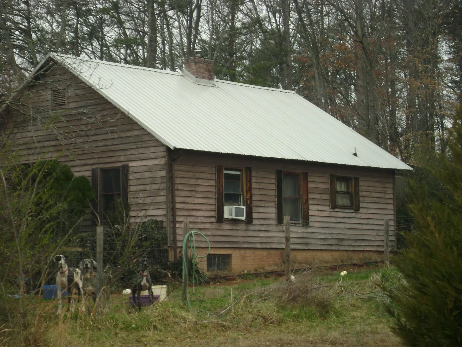 White metal roof on an old wood sided farmhouse, from a Metal Roof Installation job in North Brookfield